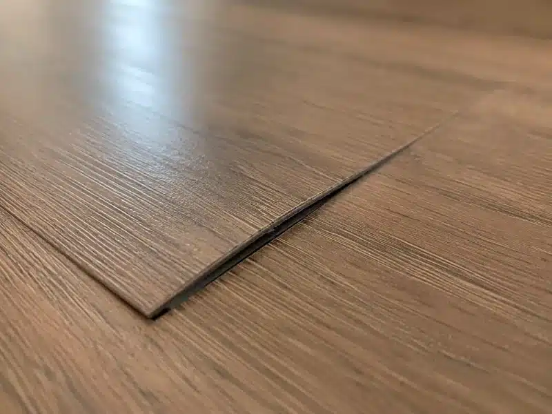 LVP locking-system damage with raised plank edge during a Reno flooring inspection