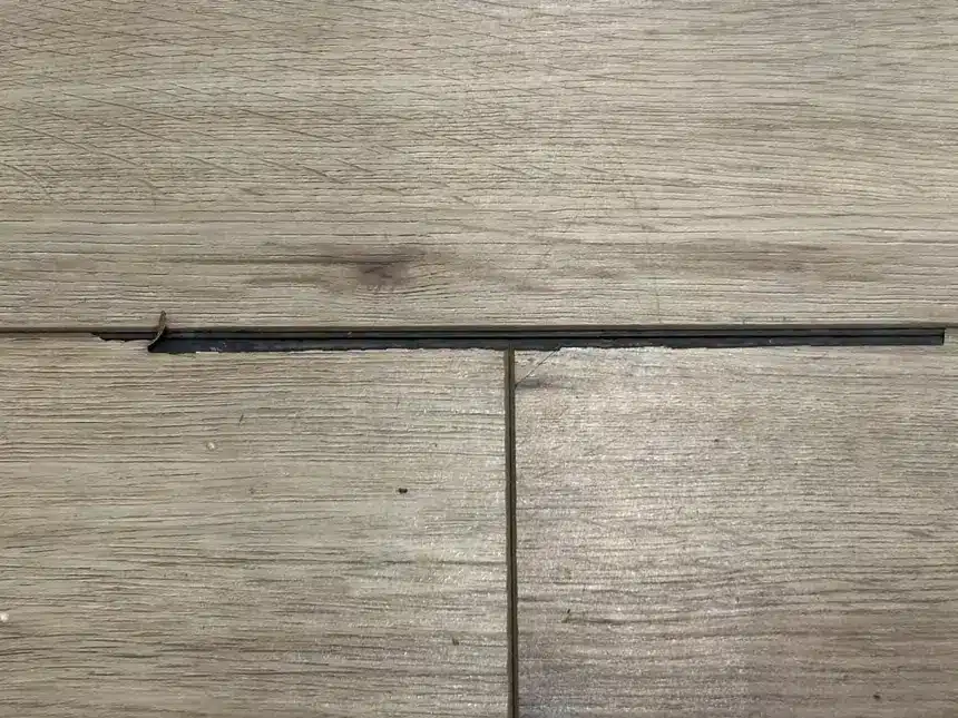 A second floor shows chipped edge material beside an exposed joint.