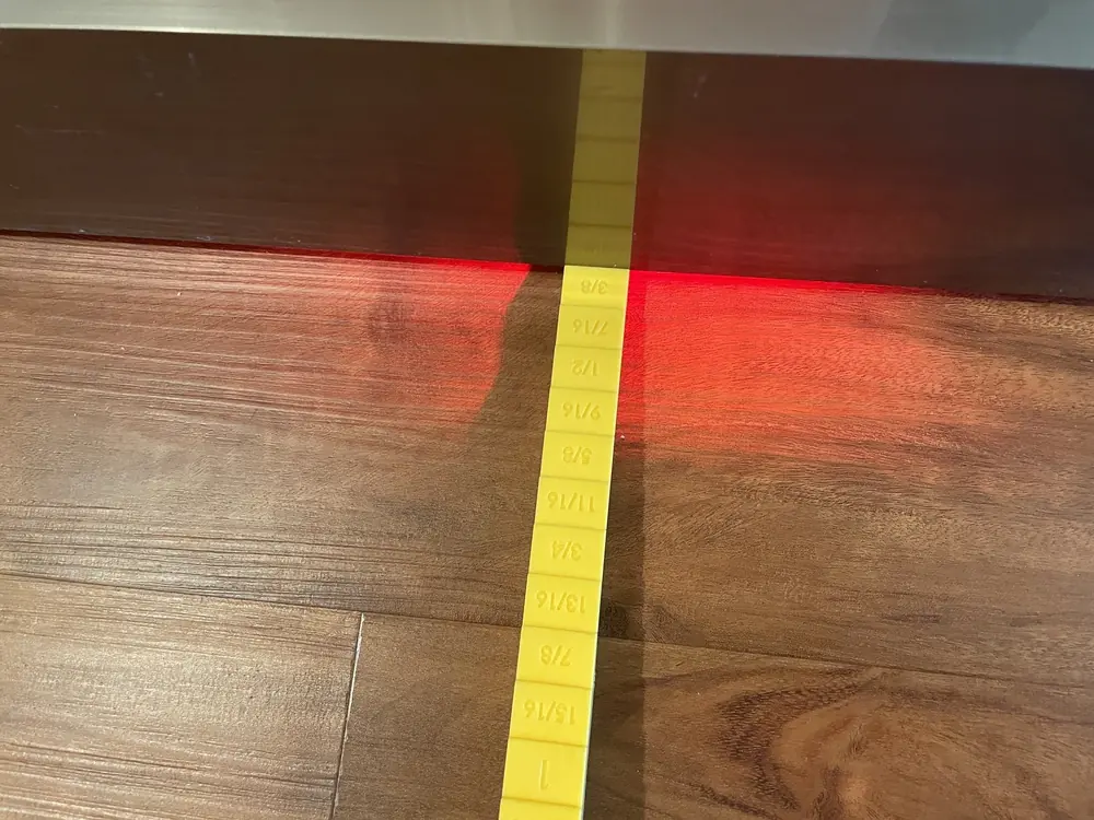 Actual flooring inspection measurement documenting surface variation near reported separation