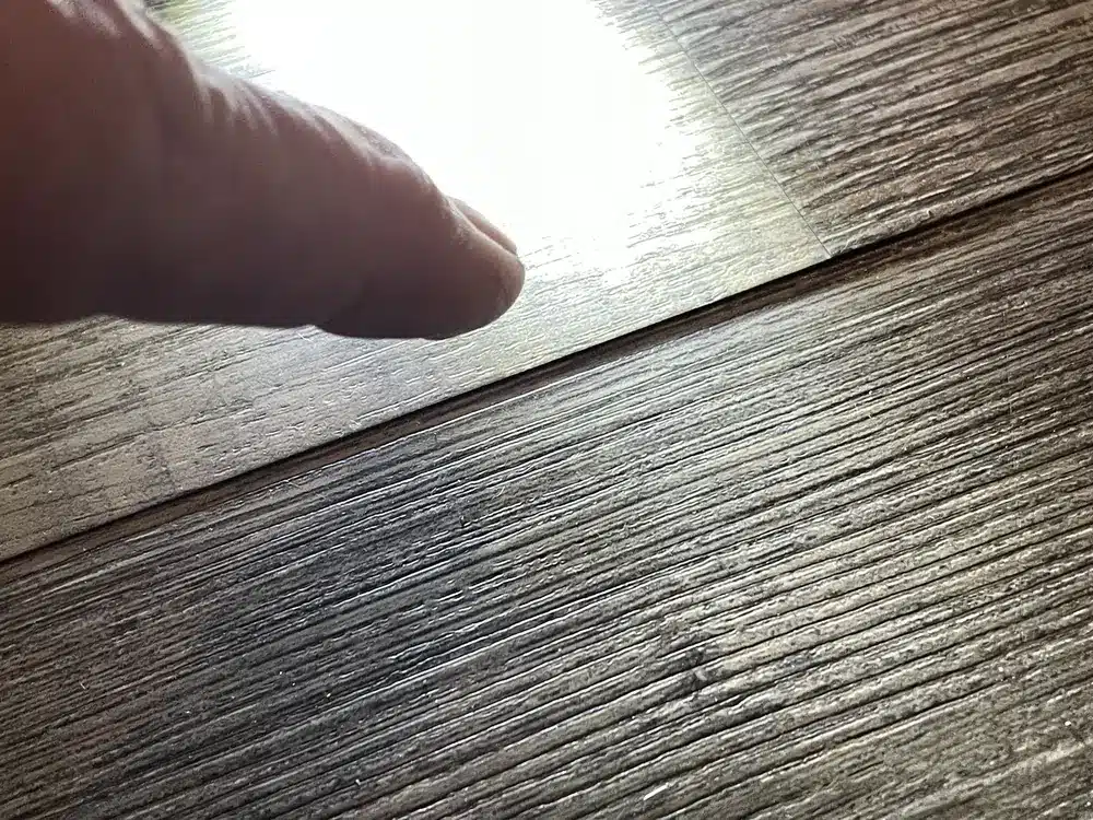 The inspector documented an edge that moved under light pressure. Do not repeatedly flex your own floor to test it.