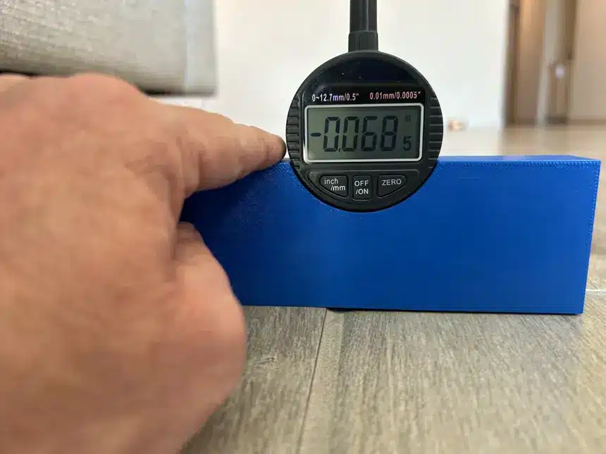 A representative digital measurement records lippage in a wood-look tile floor.